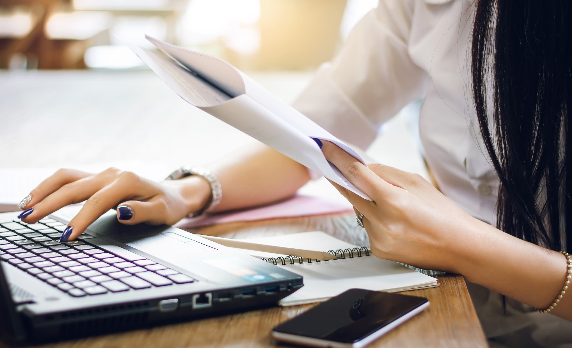 Woman on her laptop reading over the policies of the mortuary science degree