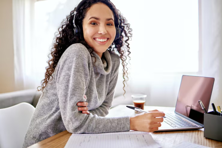 Happy female AAMI student at her desk