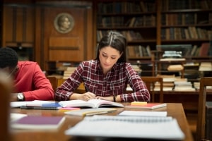 Girl in Check Shirt Studying in Library