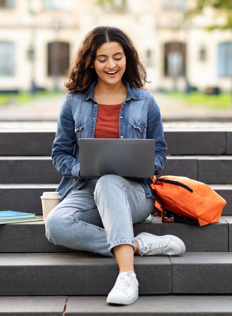 AAMI Student Looking At Her National Board Examination Results On Her Laptop
