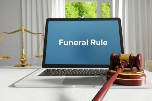 Funeral Rule Written on Laptop Screen Besides Judge Gavel