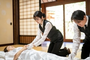 Funeral Workers Dressing the Body in Buddhist Robes