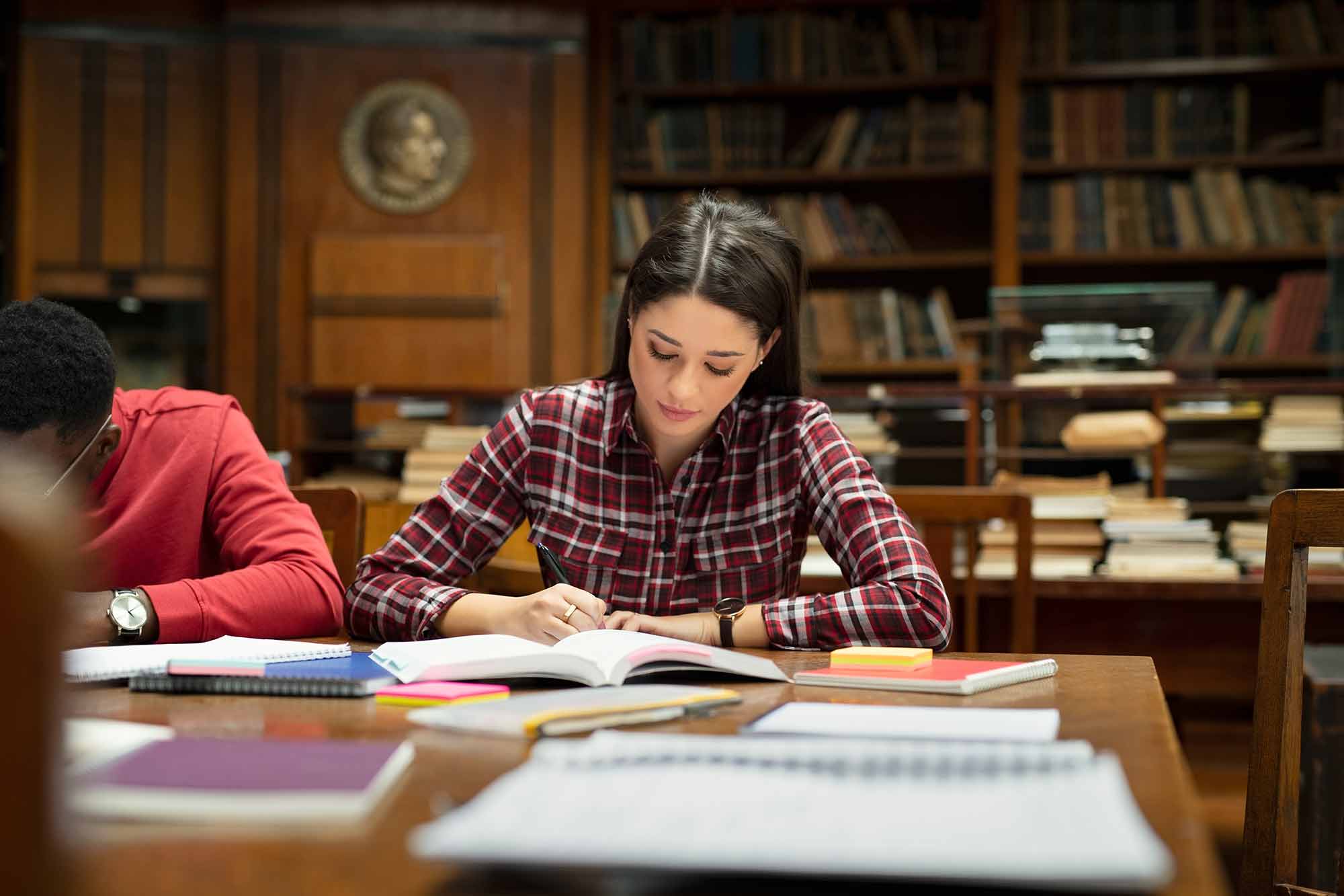 Girl-in-Checker-Shirt-Studying-in-Library