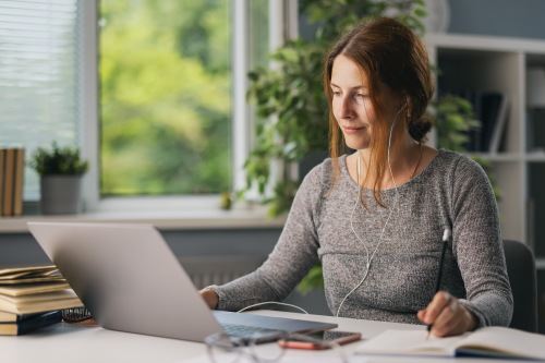 Young Female Student taking mortuary classes on laptop