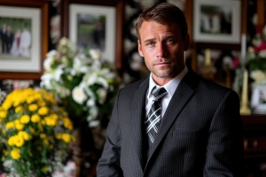Young Funeral Director Standing in Memorial Room