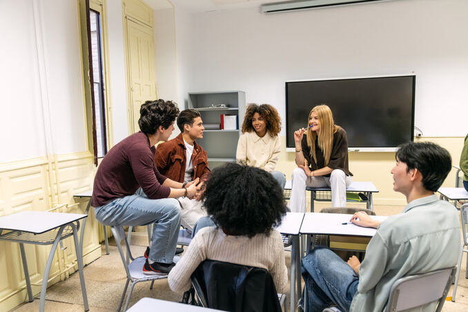 college students sitting in a circle in a classroom