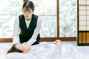 Female Embalmer Preparing Body for Funeral Service