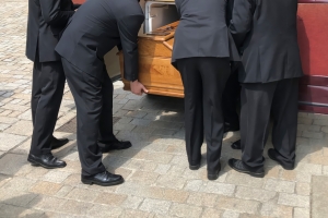 Funeral Service Crew Loading Coffin into the Hearse