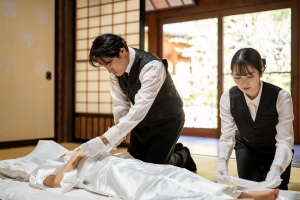 Funeral Staff Dressing the Deceased in Burial Robes